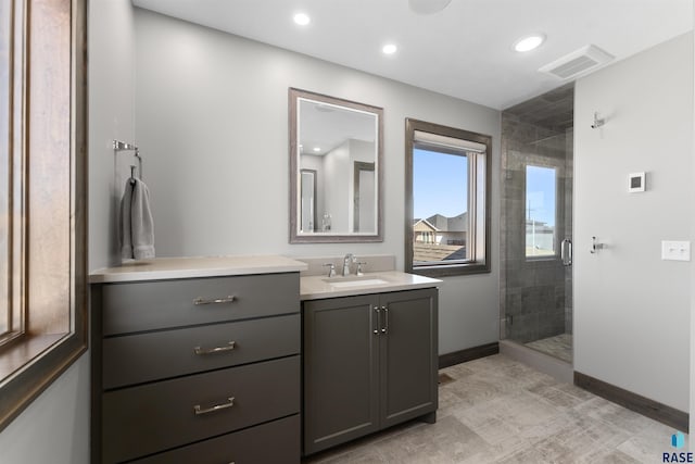 912 Torrey Pine Ln, Sioux Falls, SD 57110 - bathroom with a stall shower, vanity, baseboards, visible vents, and recessed lighting