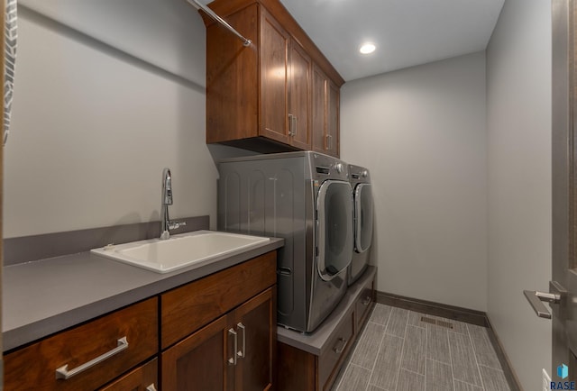 912 Torrey Pine Ln, Sioux Falls, SD 57110 - laundry room featuring visible vents, a sink, independent washer and dryer, baseboards, and cabinet space