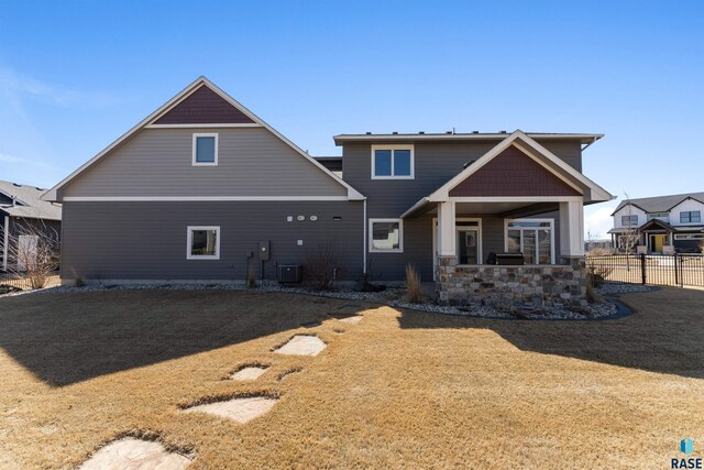 912 Torrey Pine Ln, Sioux Falls, SD 57110 - rear view of property featuring central AC unit, fence, a yard, and covered porch