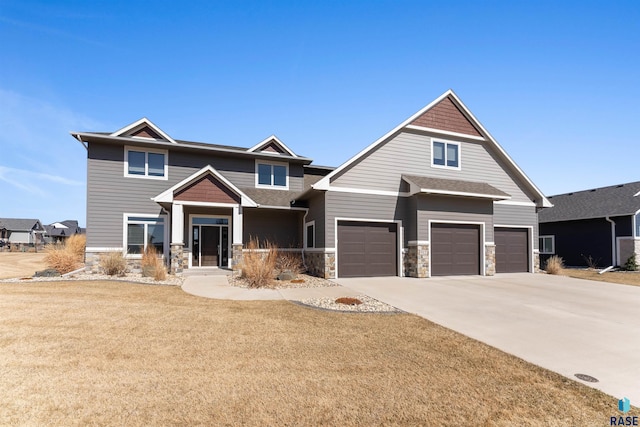 912 Torrey Pine Ln, Sioux Falls, SD 57110 - craftsman inspired home featuring a front lawn, driveway, stone siding, and a garage