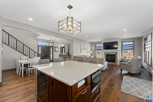 912 Torrey Pine Ln, Sioux Falls, SD 57110 - kitchen with dark wood-style floors, wine cooler, a chandelier, and stainless steel microwave