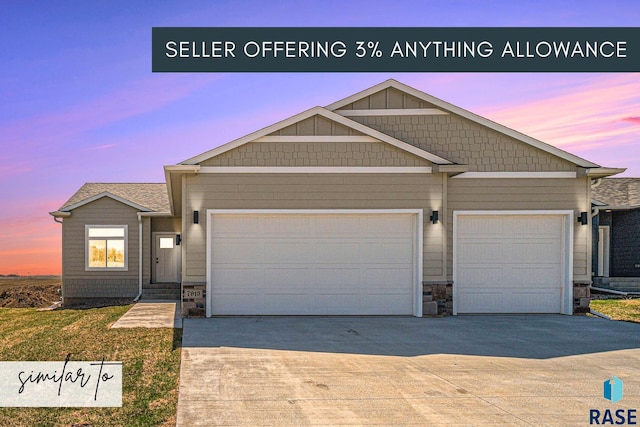 5301 E Lumin St, Sioux Falls, SD 57108 - view of front facade with an attached garage, driveway, and stone siding