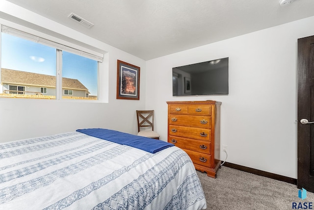 bedroom with baseboards, visible vents, and carpet flooring