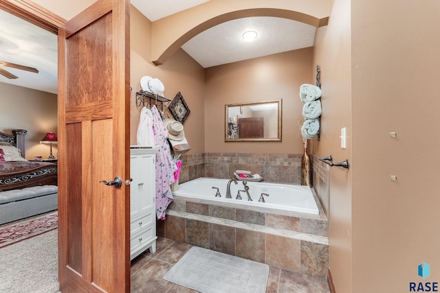 full bath featuring a bath and a ceiling fan