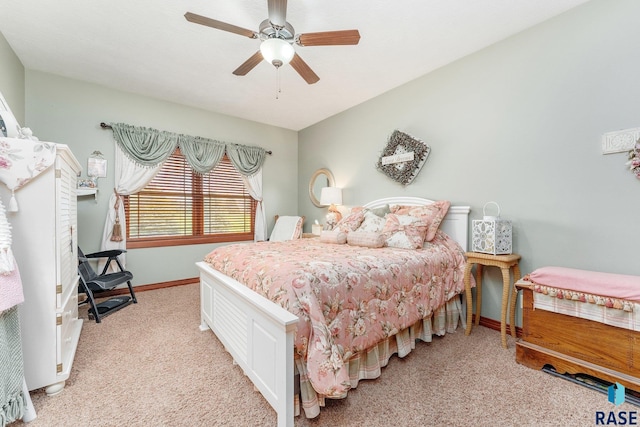 bedroom with light carpet, a ceiling fan, and baseboards
