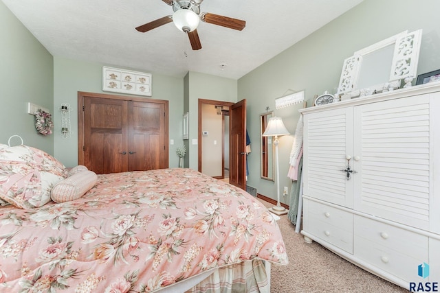 bedroom featuring ceiling fan, light carpet, and a closet