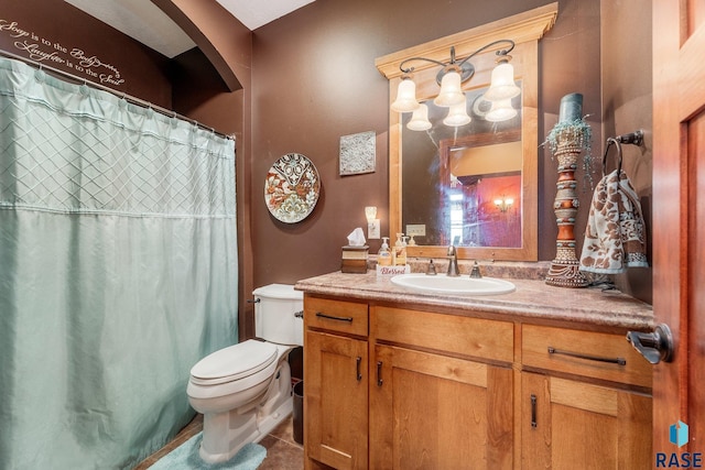 bathroom featuring curtained shower, toilet, vanity, and tile patterned floors