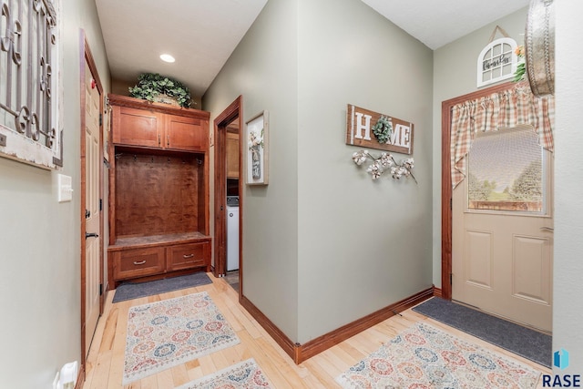 entryway featuring baseboards and light wood-style floors