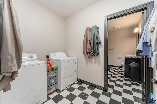 laundry area featuring washing machine and dryer, light floors, and laundry area