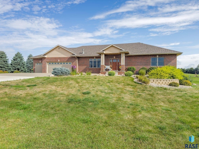 ranch-style home featuring a garage, driveway, a front yard, and brick siding