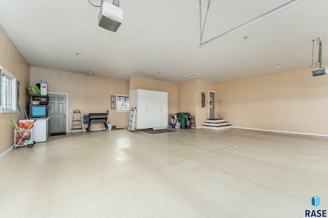 garage featuring baseboards and a garage door opener
