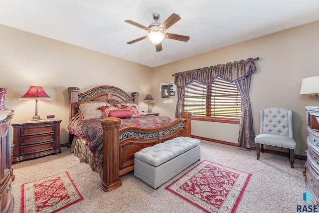 bedroom featuring ceiling fan, baseboards, and light colored carpet