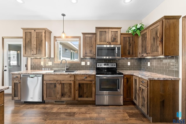 3508 E Prairie Wind St, Sioux Falls, SD 57108 - kitchen with dark wood finished floors, stainless steel appliances, visible vents, a sink, and tasteful backsplash