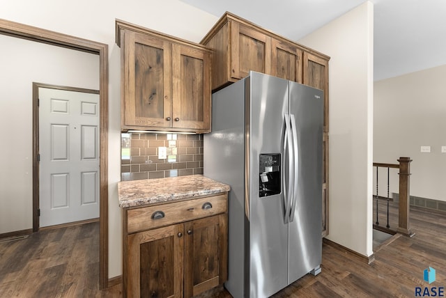 3508 E Prairie Wind St, Sioux Falls, SD 57108 - kitchen with stainless steel fridge, baseboards, decorative backsplash, light stone counters, and dark wood-type flooring