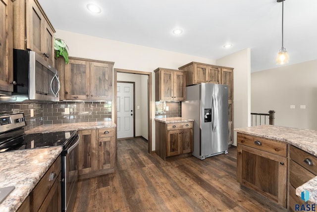 3508 E Prairie Wind St, Sioux Falls, SD 57108 - kitchen featuring stainless steel appliances, dark wood finished floors, backsplash, light stone counters, and hanging light fixtures