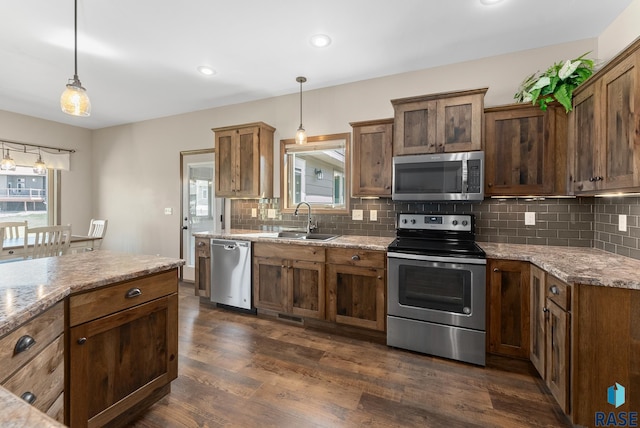 3508 E Prairie Wind St, Sioux Falls, SD 57108 - kitchen featuring backsplash, appliances with stainless steel finishes, dark wood-style floors, and a sink