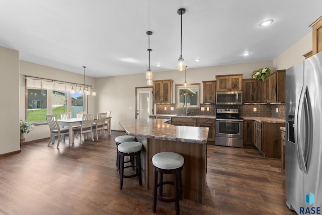 3508 E Prairie Wind St, Sioux Falls, SD 57108 - kitchen featuring backsplash, dark wood-type flooring, stainless steel appliances, and recessed lighting