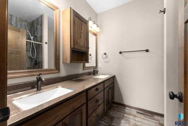 3508 E Prairie Wind St, Sioux Falls, SD 57108 - bathroom with wood finished floors, a sink, visible vents, and double vanity