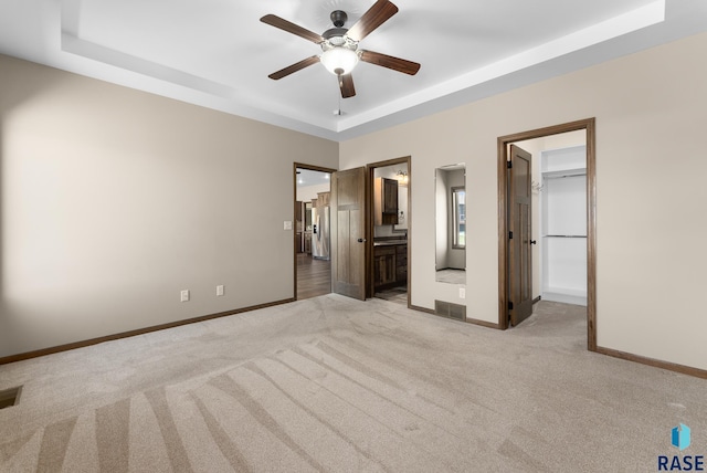 3508 E Prairie Wind St, Sioux Falls, SD 57108 - unfurnished bedroom featuring a tray ceiling, carpet floors, baseboards, and stainless steel fridge with ice dispenser