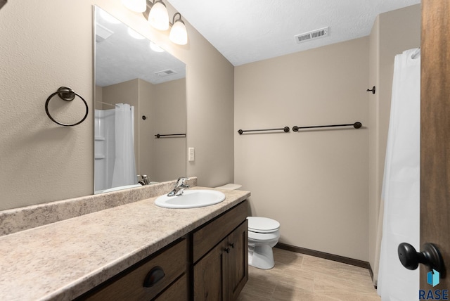 3508 E Prairie Wind St, Sioux Falls, SD 57108 - full bathroom with baseboards, visible vents, toilet, and vanity