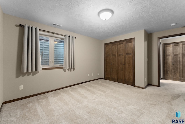 3508 E Prairie Wind St, Sioux Falls, SD 57108 - unfurnished bedroom featuring baseboards, carpet floors, visible vents, and a textured ceiling
