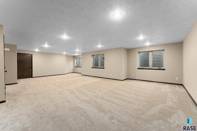 3508 E Prairie Wind St, Sioux Falls, SD 57108 - basement with baseboards, carpet flooring, and a textured ceiling