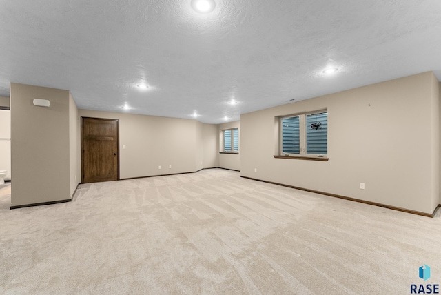 3508 E Prairie Wind St, Sioux Falls, SD 57108 - basement with recessed lighting, baseboards, a textured ceiling, and light colored carpet