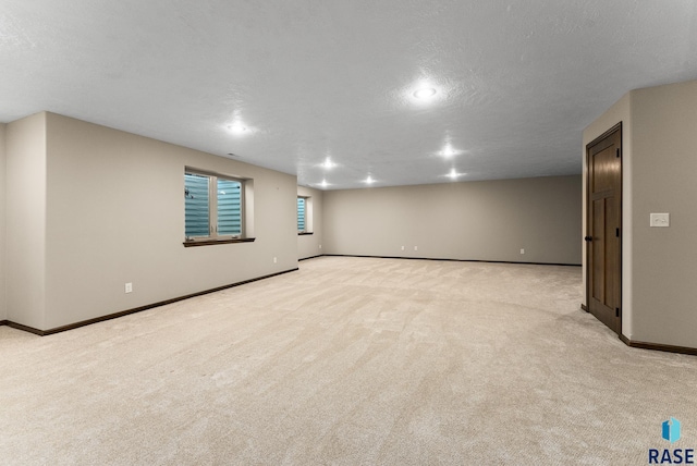 3508 E Prairie Wind St, Sioux Falls, SD 57108 - basement featuring light colored carpet, baseboards, and a textured ceiling