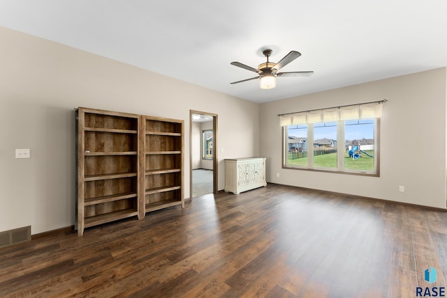 3508 E Prairie Wind St, Sioux Falls, SD 57108 - spare room with baseboards, visible vents, ceiling fan, and dark wood-style flooring