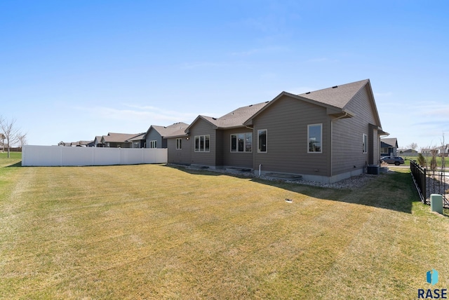 3508 E Prairie Wind St, Sioux Falls, SD 57108 - rear view of house featuring central AC, fence, and a yard