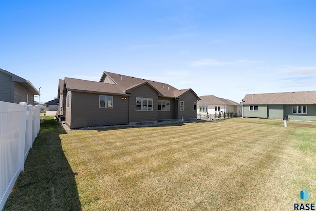 3508 E Prairie Wind St, Sioux Falls, SD 57108 - back of property featuring fence, a lawn, and a residential view