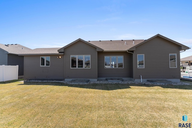 3508 E Prairie Wind St, Sioux Falls, SD 57108 - rear view of property featuring fence, roof with shingles, and a yard