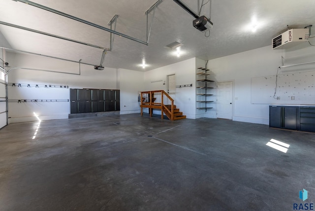 3508 E Prairie Wind St, Sioux Falls, SD 57108 - garage featuring a heating unit, baseboards, and a garage door opener