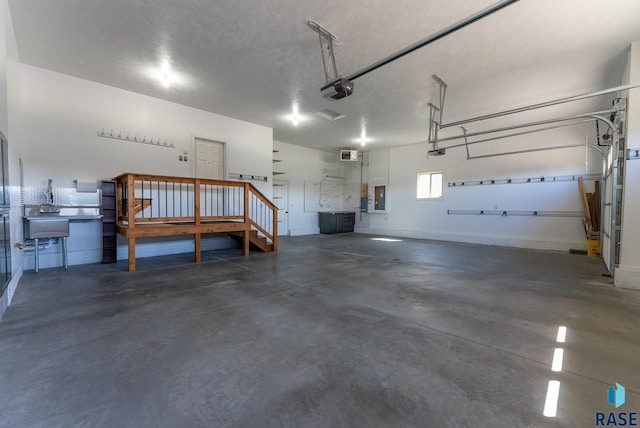 3508 E Prairie Wind St, Sioux Falls, SD 57108 - garage featuring baseboards, a garage door opener, and electric panel