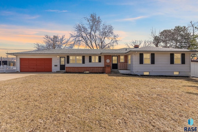 ranch-style home with crawl space, a garage, driveway, a front yard, and roof with shingles