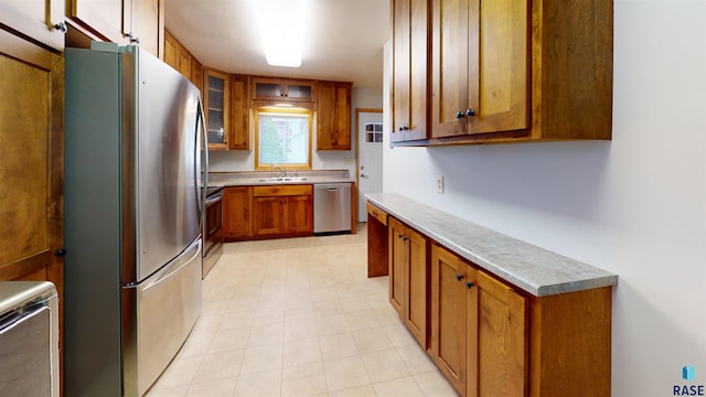 1516 S W Ave, Sioux Falls, SD 57105 - kitchen with appliances with stainless steel finishes, brown cabinets, light countertops, and glass insert cabinets