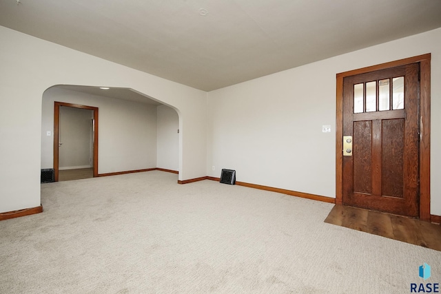 1330 W 14th St, Sioux Falls, SD 57104 - foyer entrance featuring arched walkways, carpet flooring, and baseboards