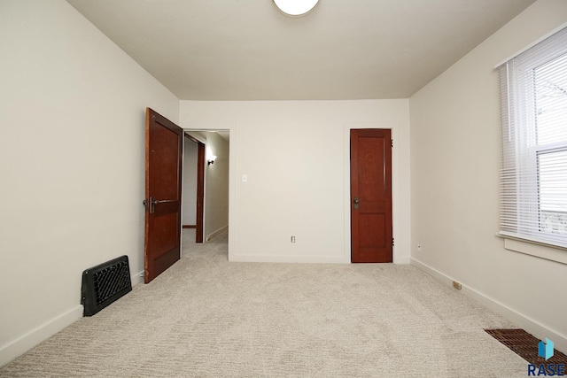 1330 W 14th St, Sioux Falls, SD 57104 - spare room with visible vents, baseboards, and light carpet