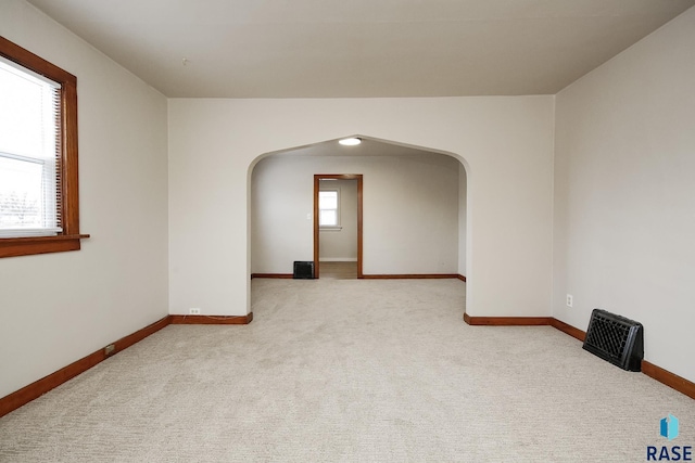 1330 W 14th St, Sioux Falls, SD 57104 - unfurnished room with arched walkways, carpet floors, and baseboards