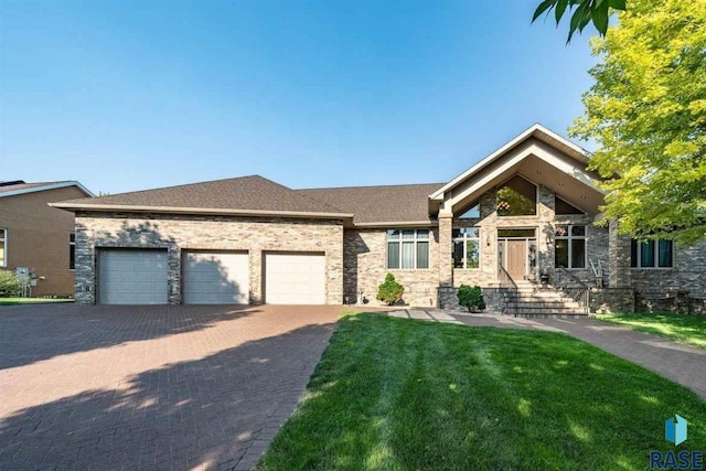 6301 S Grand Prairie Dr, Sioux Falls, SD 57108 - view of front of house with roof with shingles, an attached garage, decorative driveway, brick siding, and a front yard