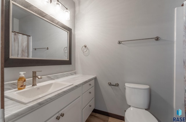 full bath featuring wood finished floors, toilet, and vanity