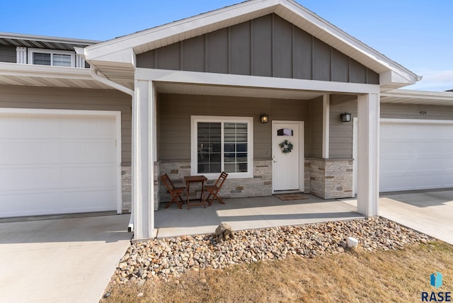 ranch-style house featuring an attached garage, driveway, a porch, and board and batten siding