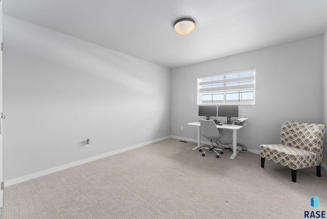 carpeted office space featuring baseboards
