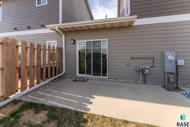rear view of house with fence and a patio