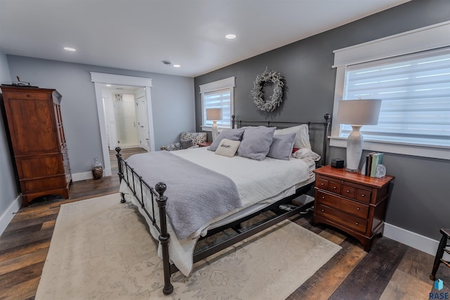 bedroom featuring baseboards, recessed lighting, and dark wood finished floors