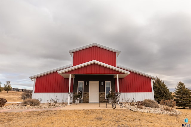 view of front of property featuring stone siding and covered porch