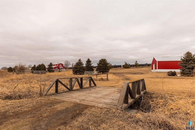 view of yard with a rural view and an outbuilding