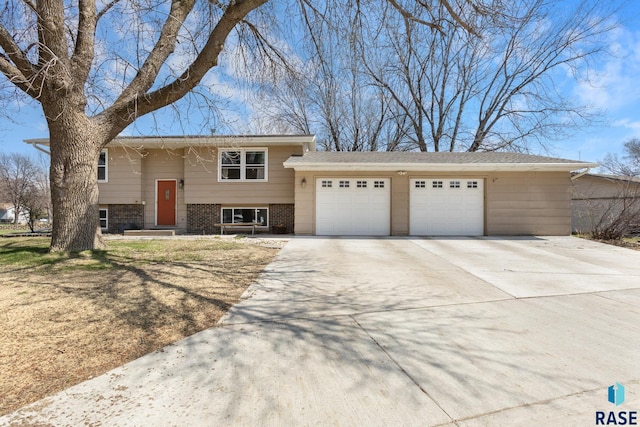 200 Perry Ln, Harrisburg, SD 57032 - raised ranch with a garage, brick siding, and concrete driveway