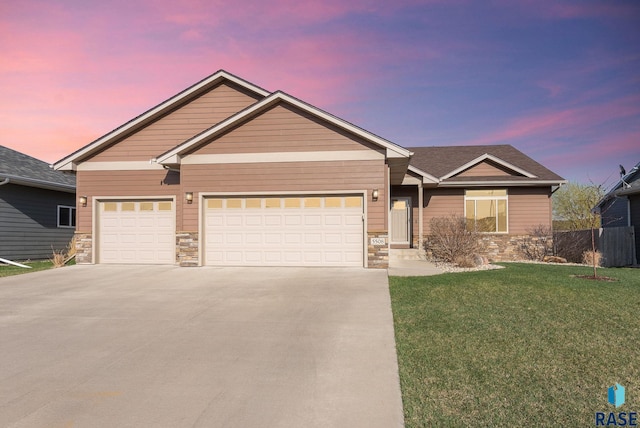 5508 S Sirocco Ave, Sioux Falls, SD 57108 - view of front of home with a yard, stone siding, and concrete driveway