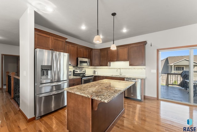 5508 S Sirocco Ave, Sioux Falls, SD 57108 - kitchen with light wood-style flooring, light stone countertops, appliances with stainless steel finishes, and a sink